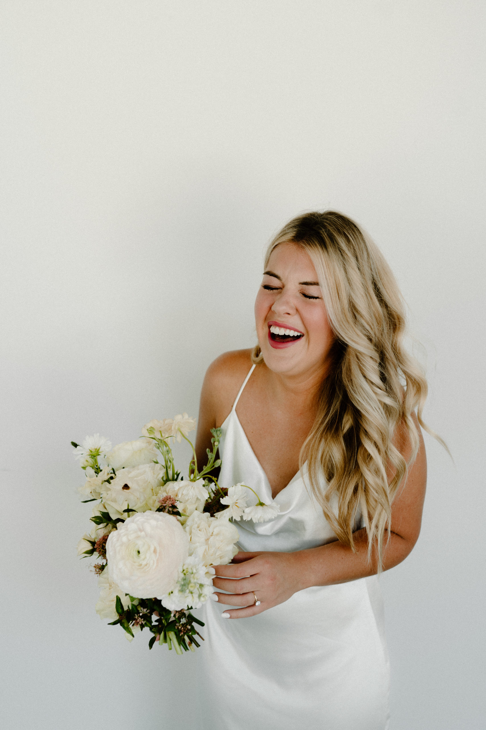 Laughing bride with flowers
